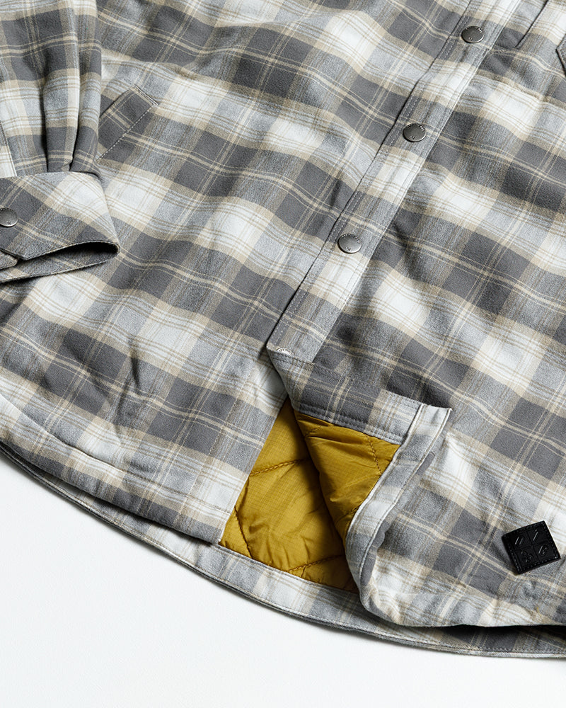 Off The Grid Surplus Ironside Flannel Castlerock jacket with button closure and rugged plaid design, displayed on a hanger.