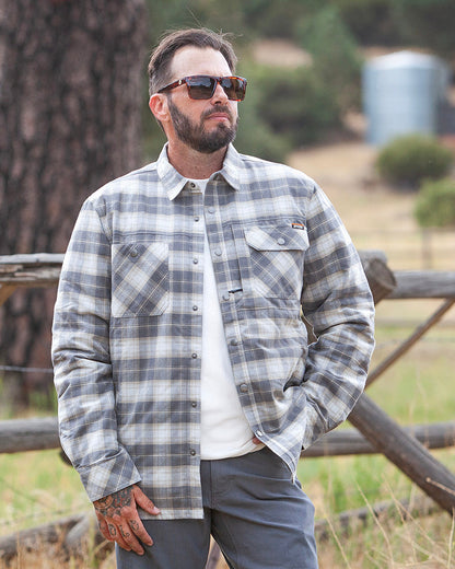 Off The Grid Surplus Ironside Flannel Castlerock jacket, rugged outdoor-style with plaid pattern and button closure.