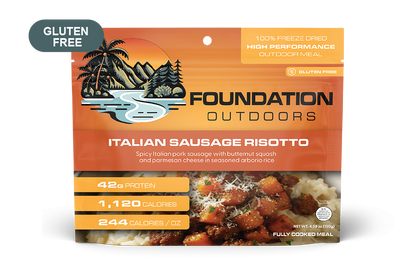 Creamy Spicy Italian Pork Sausage Risotto served on a plate, featuring chunks of sausage and garnished with herbs.