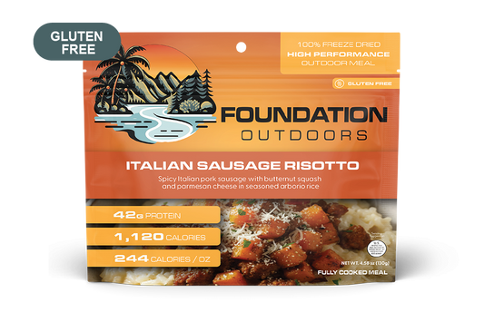 Creamy Spicy Italian Pork Sausage Risotto served on a plate, featuring chunks of sausage and garnished with herbs.