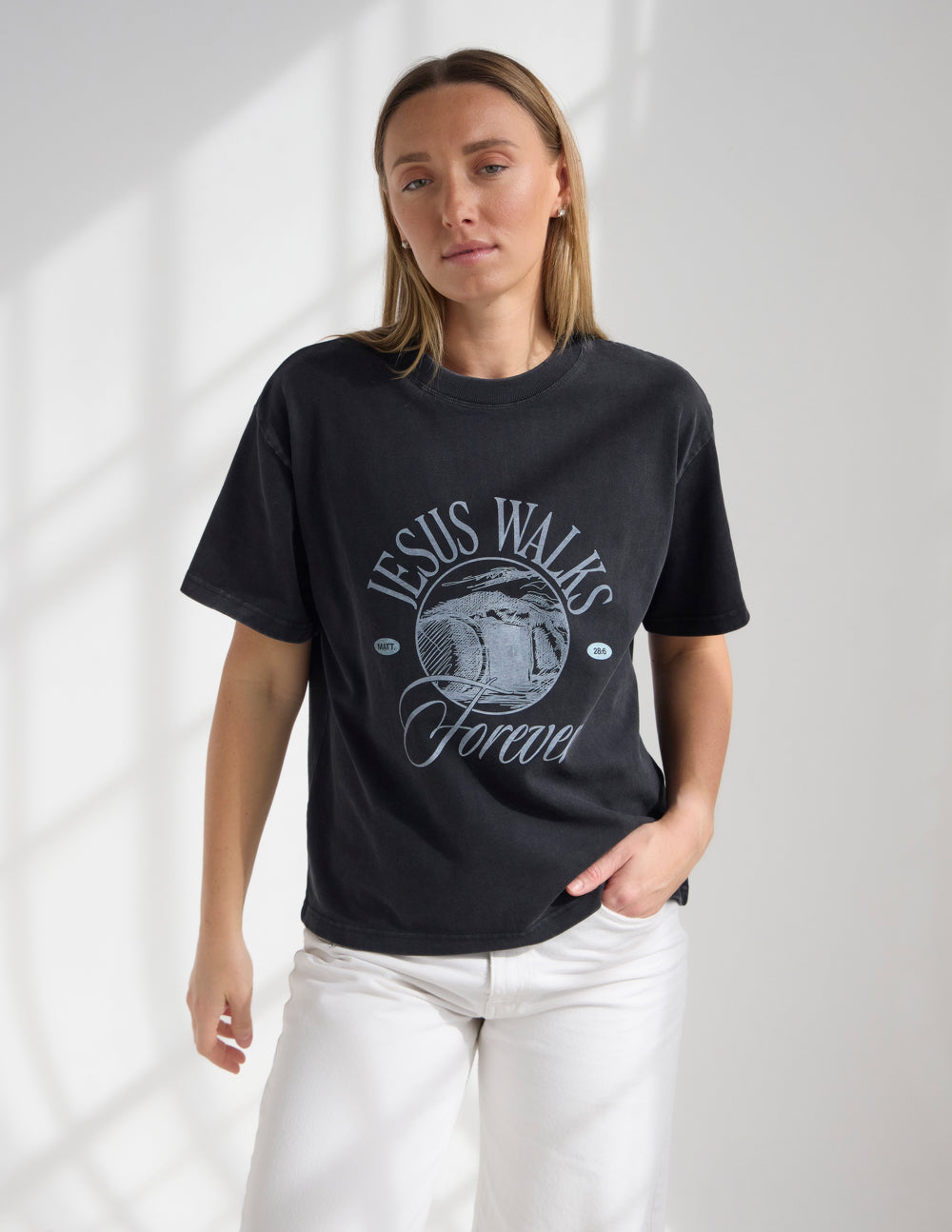 Black Jesus Walks heavyweight T-shirt by Elevated Faith featuring bold graphic design on the front.