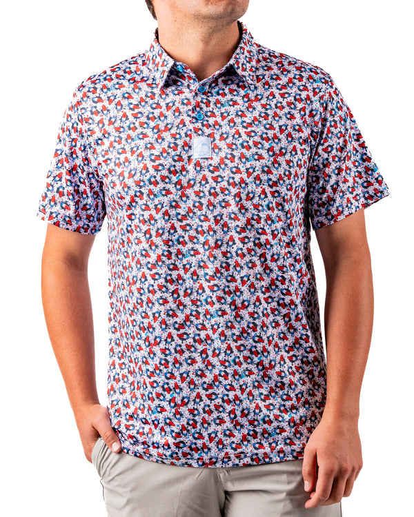 Men's Bomb Pop Splatter polo shirt by Pins and Aces featuring a colorful, playful July 4th-inspired design.