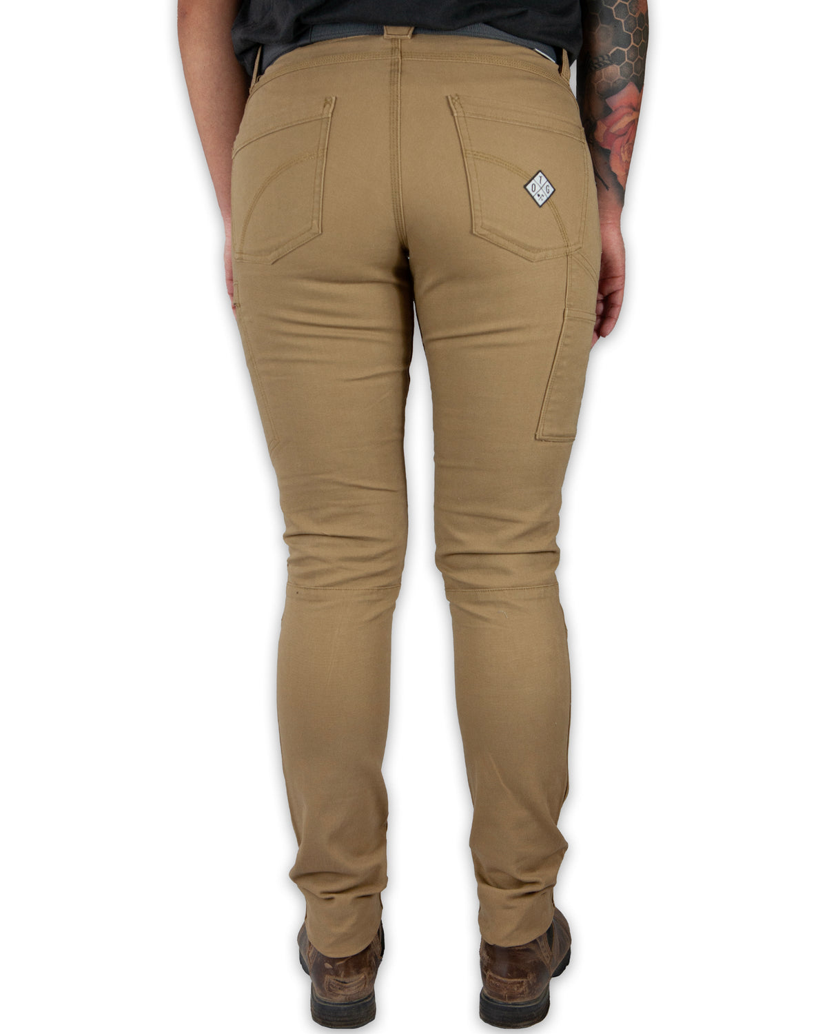 Kestral Women's Coyote Pants by Off The Grid Surplus, showing rugged outdoor style and durable fabric in a natural pose.