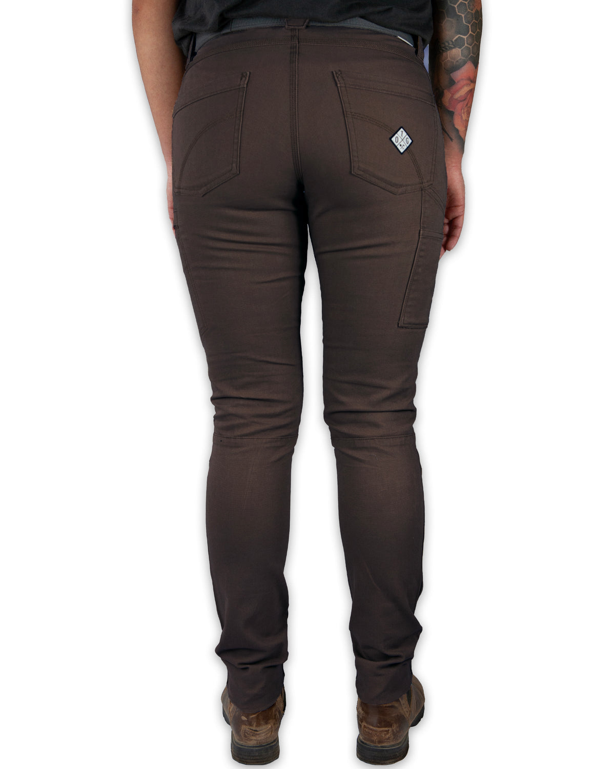 Dark brown Kestral women's pants from Off The Grid Surplus, shown hanging with a relaxed fit and detailed stitching.