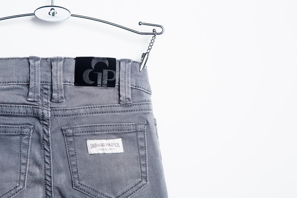Gray biker jeans by IndigoPaper, featuring a slim fit with detailed stitching and classic five-pocket design.