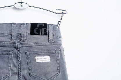 Gray biker jeans by IndigoPaper, featuring a slim fit with detailed stitching and classic five-pocket design.