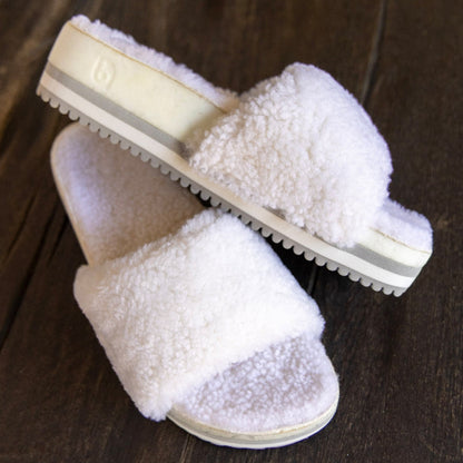 Fleks San Ysidro Cito Slide in Iceberg color, casual slip-on footwear with cushioned sole, worn outdoors on a wooden deck.