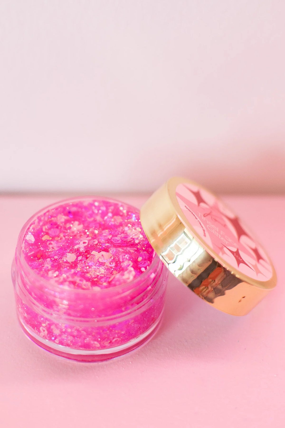 Kismet Stronger in Pink Breast Cancer Awareness glitter shop sign with pink and white lettering on a sparkly background.
