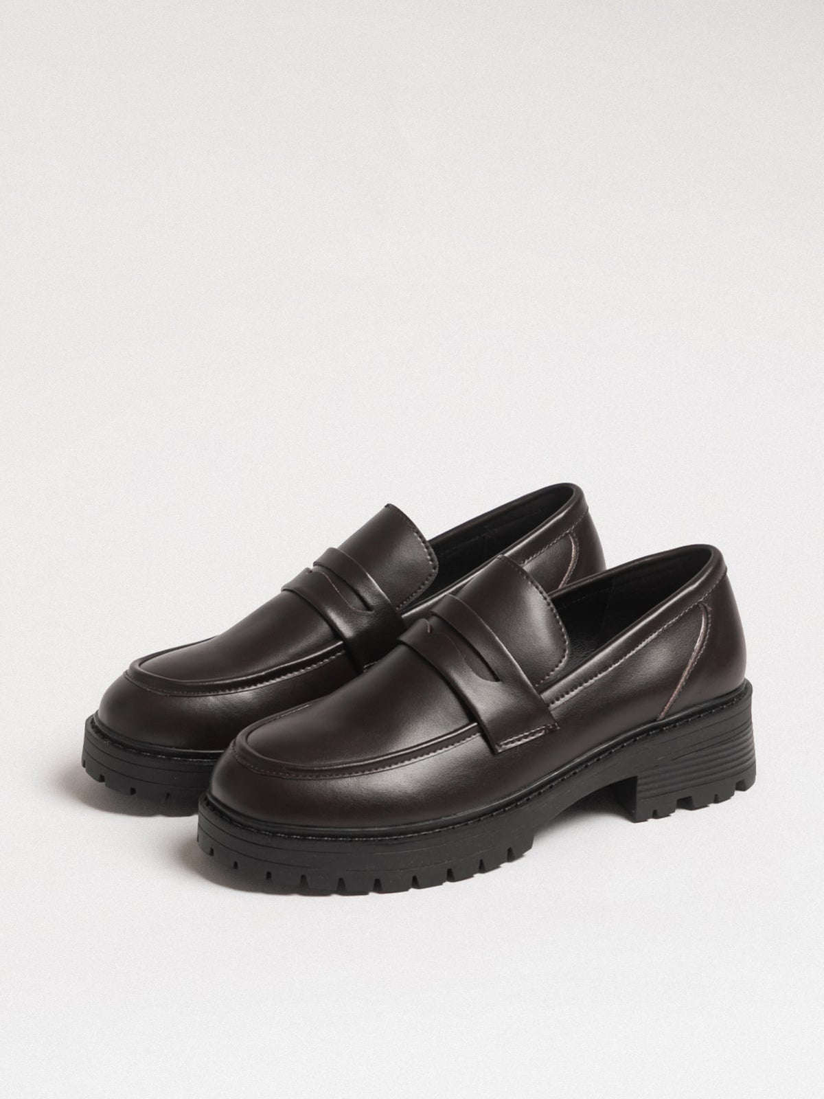 Women's leather footwear by L'ARTE MILANO featuring dark brown stylish shoes with a sleek design.