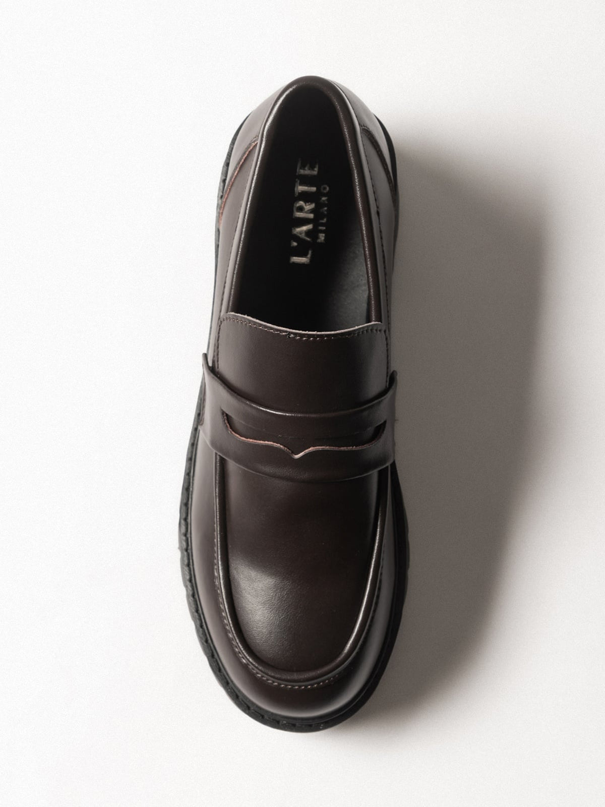 Women's leather footwear by L'ARTE MILANO, stylish dark brown shoes with sleek design and comfortable fit.