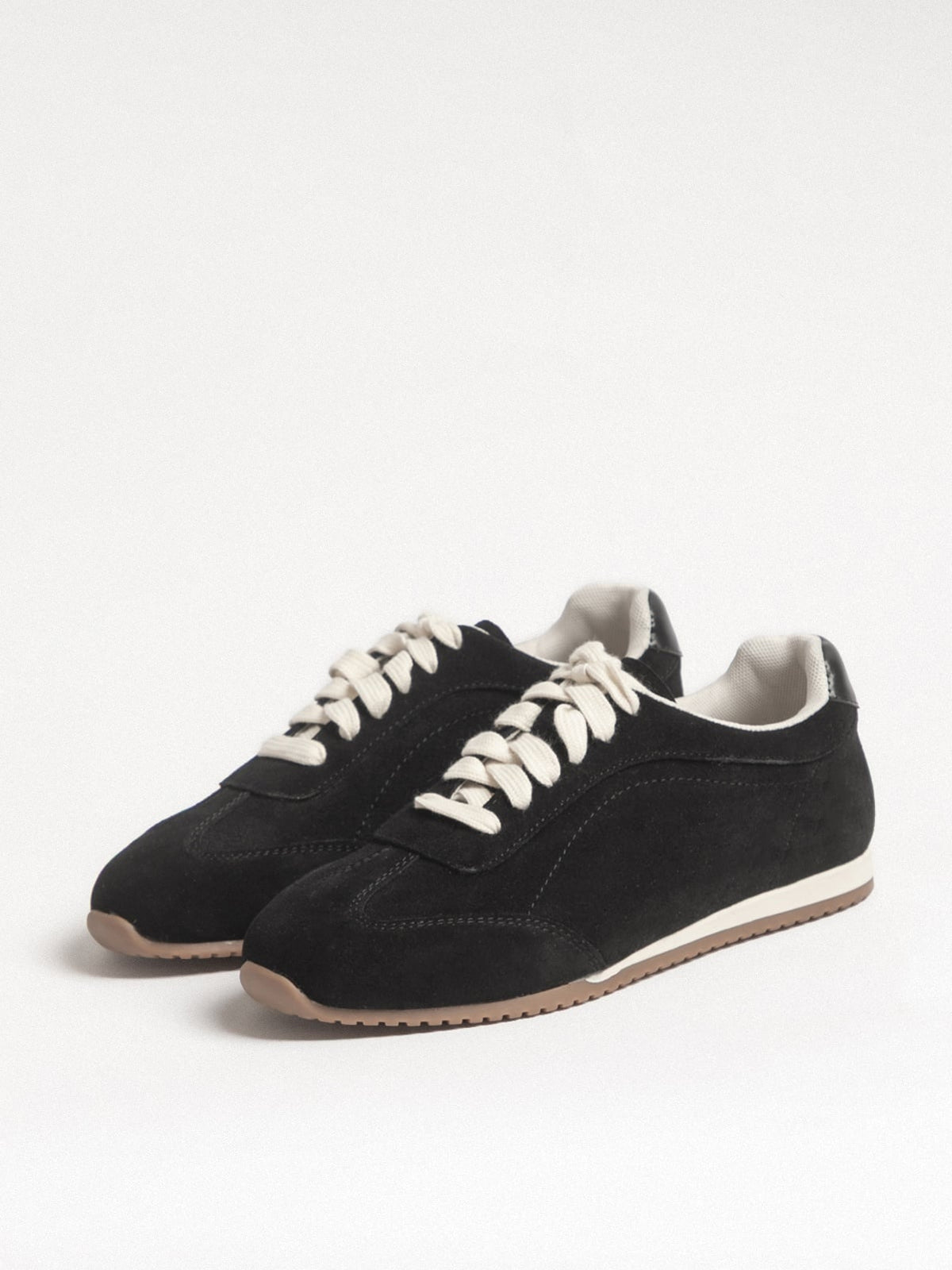 Black women's leather casual shoes by L'ARTE MILANO, showcasing stylish slip-on footwear with smooth leather finish.