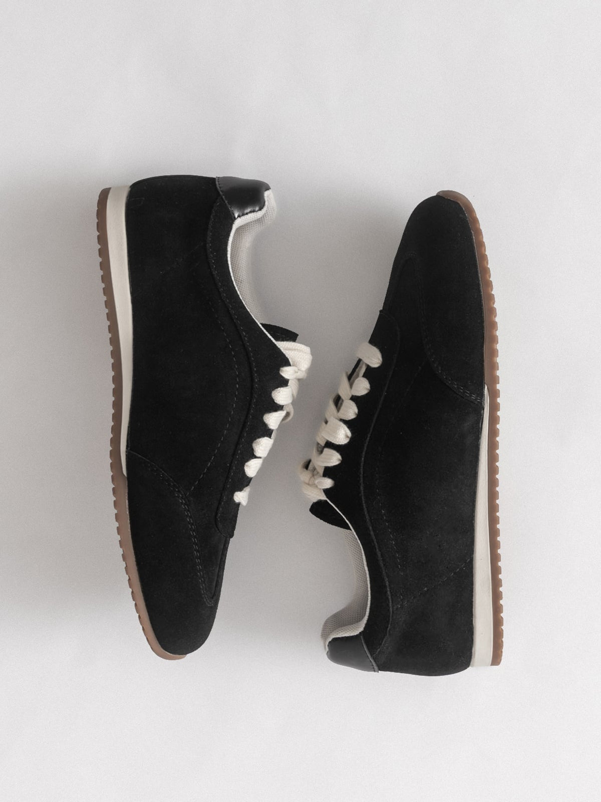 Black women's leather casual shoes by L'ARTE MILANO, showcasing stylish slip-on footwear with a smooth leather finish.