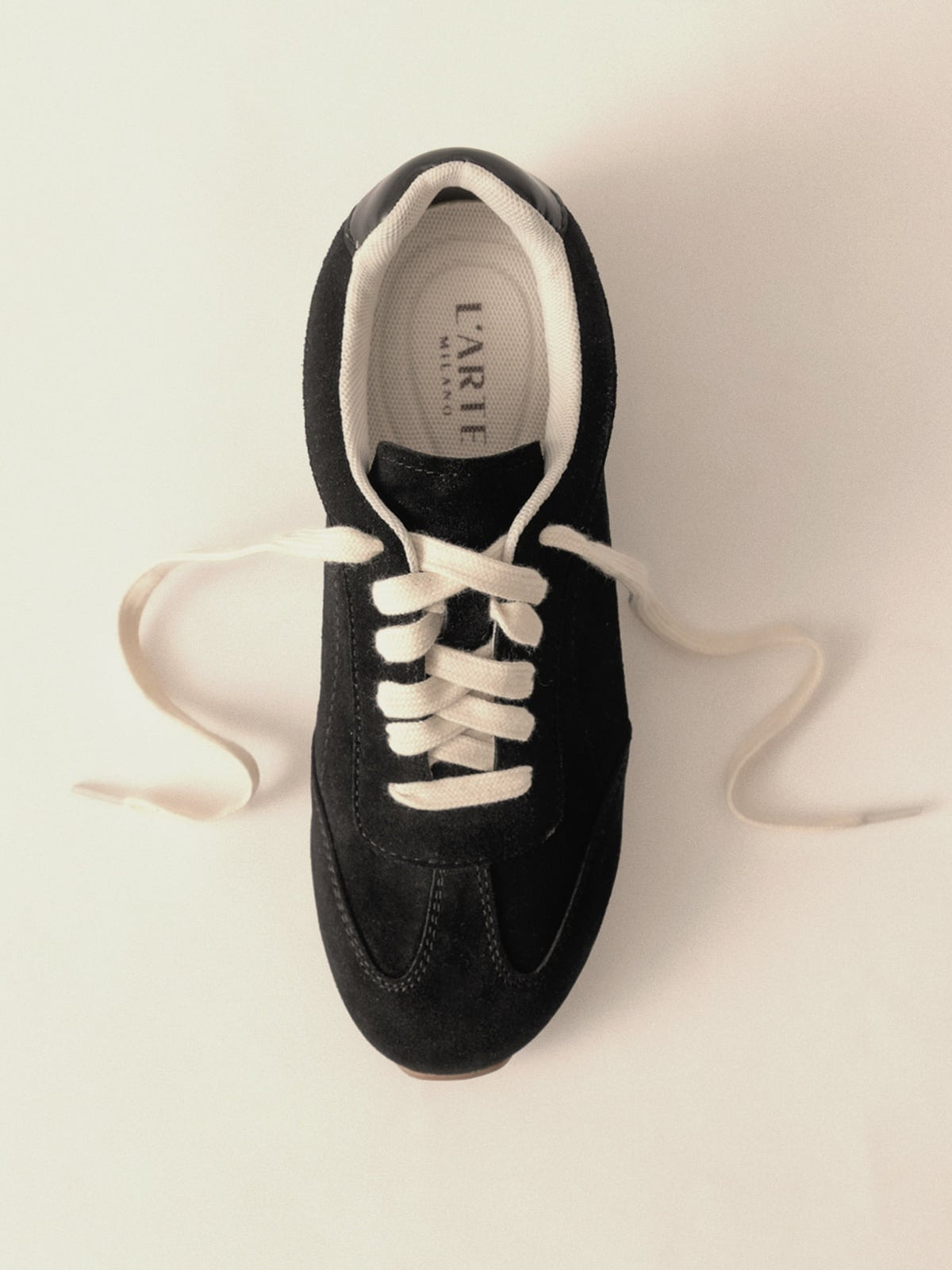 Women's black leather casual shoes by L'ARTE MILANO, showcasing stylish footwear with a sleek design and comfortable fit.