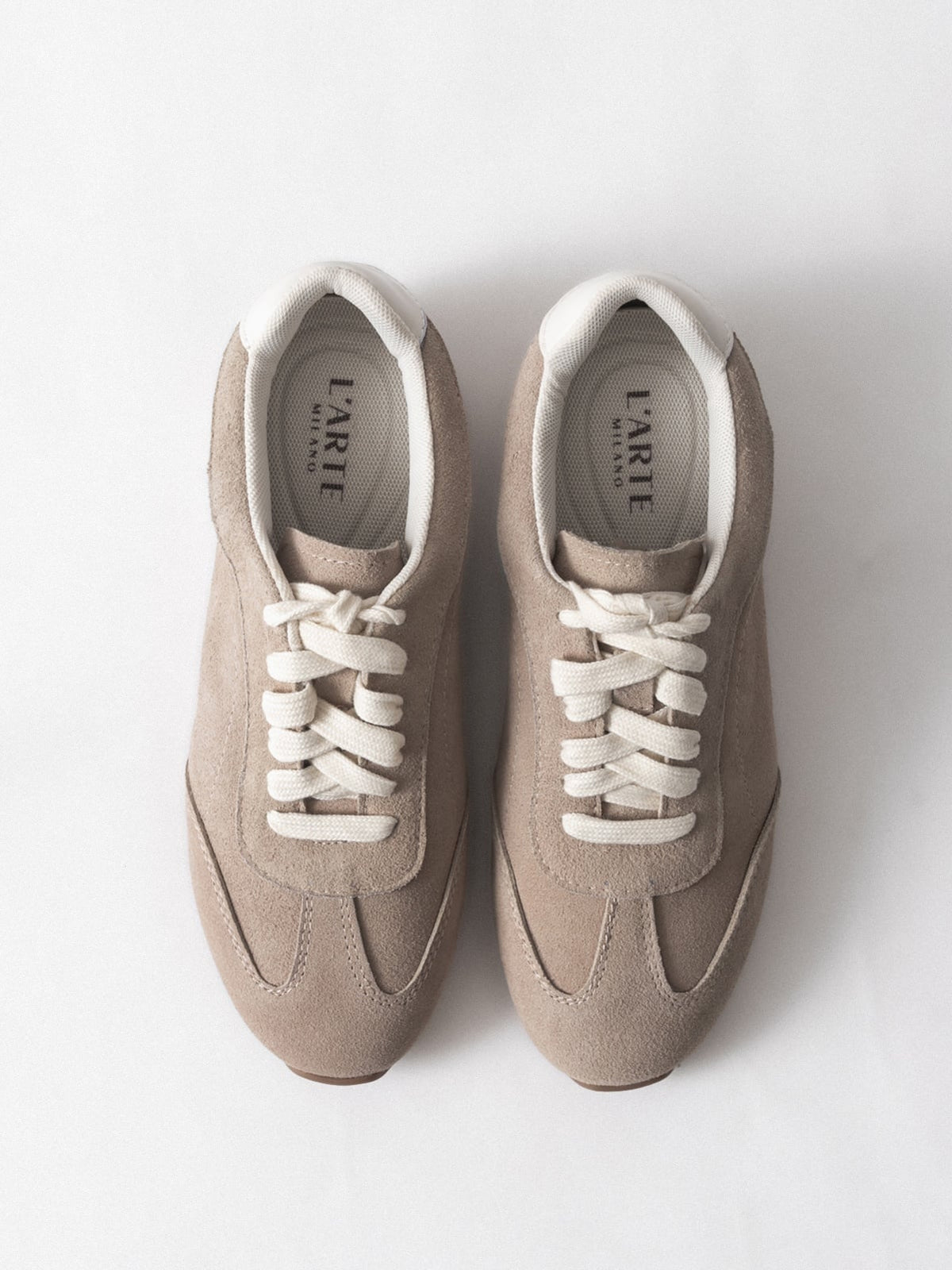 Women's leather casual shoes by L'ARTE MILANO, dark sand color, showing stylish slip-on footwear with smooth leather finish.