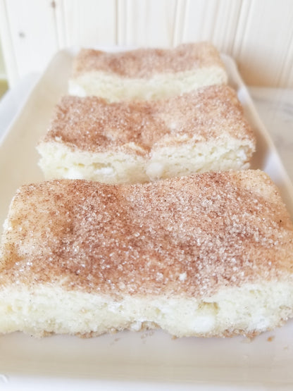 White chocolate snickerdoodle blondies from Let's Get Baked Artisan Desserts, showing golden dessert bars with cinnamon sugar topping.