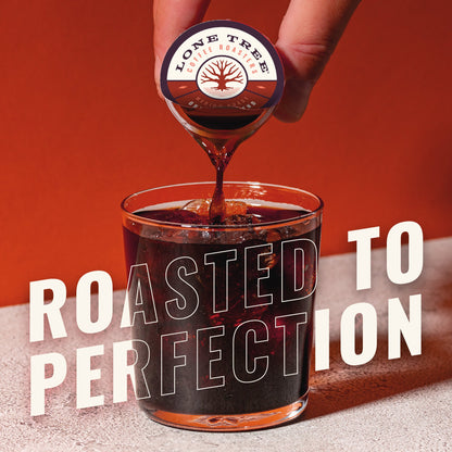Java House Lone Tree Coffee Roasters medium roast coffee in a cup with a coffee maker, showcasing the Original Blend in a cozy setting.