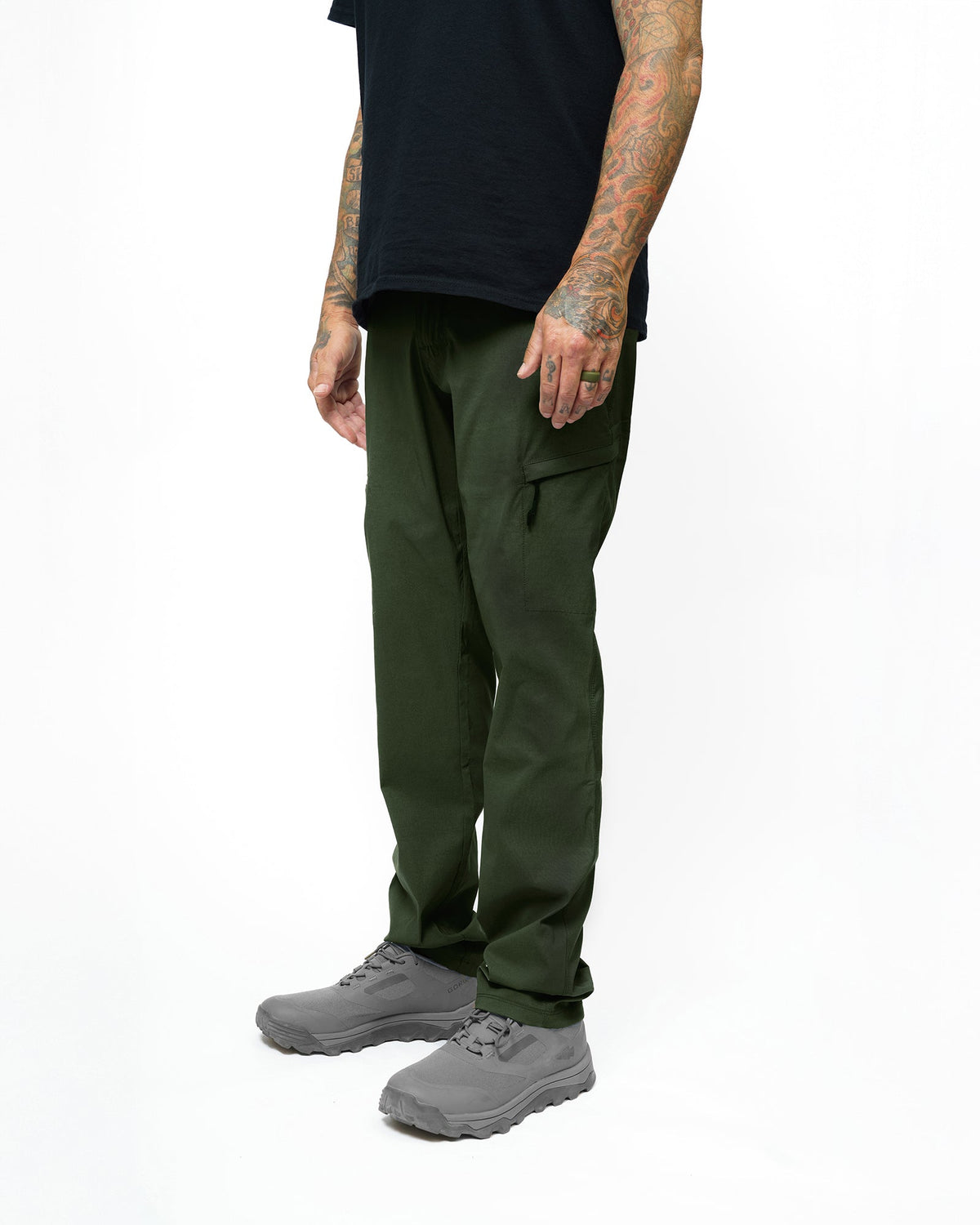 Dark army green taper fit pants by Off The Grid Surplus, featuring a sleek design and modern fit, shown on a model.