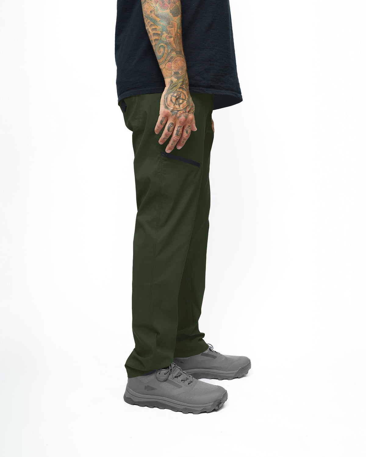 Dark army green Lancer taper fit pants by Off The Grid Surplus, showing the relaxed fit and tapered design on a hanger.