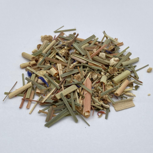 Herbal lemongrass ginger loose leaf tea in a clear glass jar, showcasing fresh, vibrant yellow and green tea leaves and herbs.
