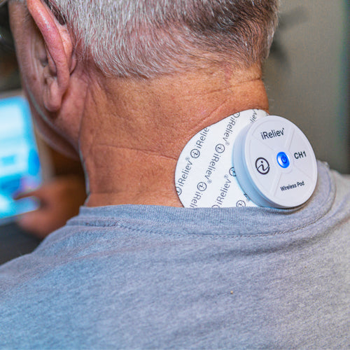iReliev wireless large single pads refill kit for TENS and EMS therapy, shown in lifestyle setting