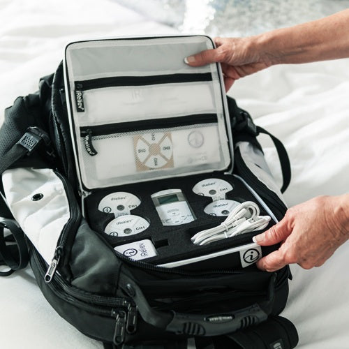 iReliev wireless TENS EMS protective carry case in a lifestyle setting, showcasing durable accessories for safe transport.