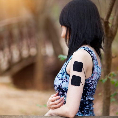 iReliev TENS Unit for pain relief and muscle recovery, shown in a lifestyle setting with handheld device and electrode pads.