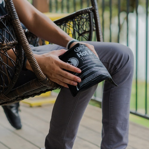 iReliev premium reusable hot and cold therapy gel pack with securement straps in a lifestyle setting, designed for pain relief and cold therapy.