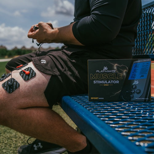 iReliev SPORT TENS + EMS muscle stimulator device used on arm in a lifestyle setting, demonstrating pain relief and muscle recovery.