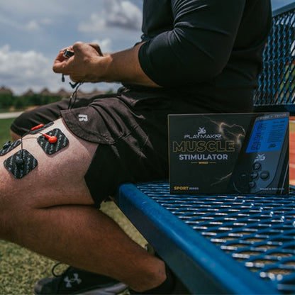 iReliev SPORT TENS + EMS muscle stimulator device used on arm in a lifestyle setting, demonstrating pain relief and muscle recovery.