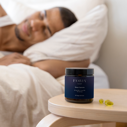 Foria Sleep Capsules in a bottle, natural lifestyle scene showing these herbal capsules designed to promote restful sleep.
