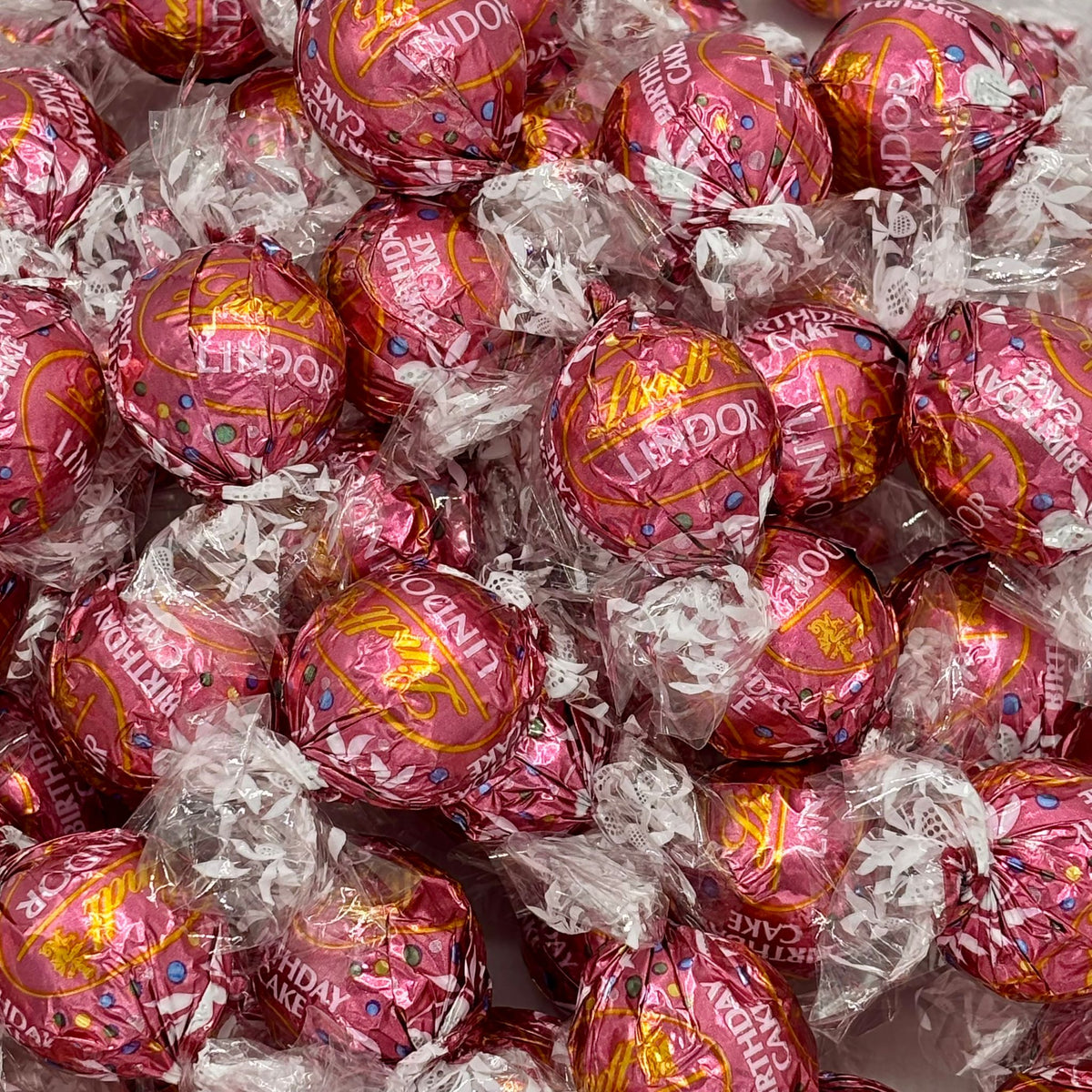 Lindt LINDOR Birthday Cake White Chocolate Truffles in a bulk bag, featuring smooth white chocolate with colorful birthday cake-inspired accents.