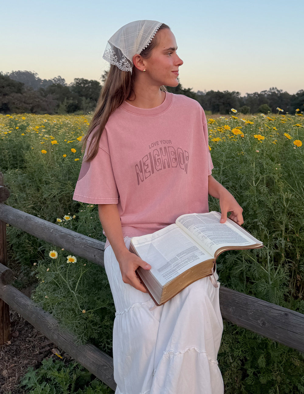 Black heavyweight T-shirt by Elevated Faith featuring a "Love Your Neighbor" graphic design on the front.
