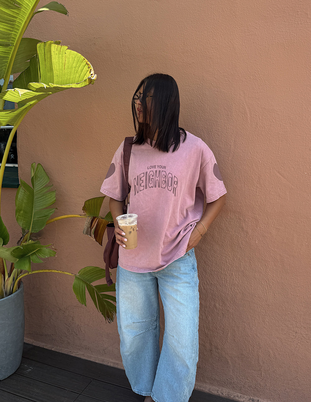 Black heavyweight T-shirt by Elevated Faith featuring a "Love Your Neighbor" graphic design on the front.
