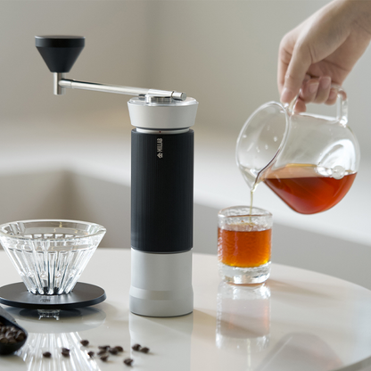Timemore X Millab M01 coffee grinder with stainless steel body and manual crank for home brewing.