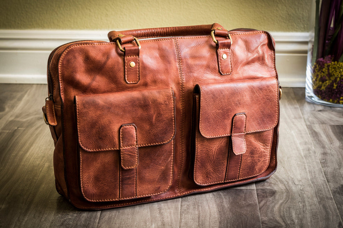 Black Kiko commuter briefcase bag with handle and shoulder strap, featuring multiple compartments and a sleek professional design.