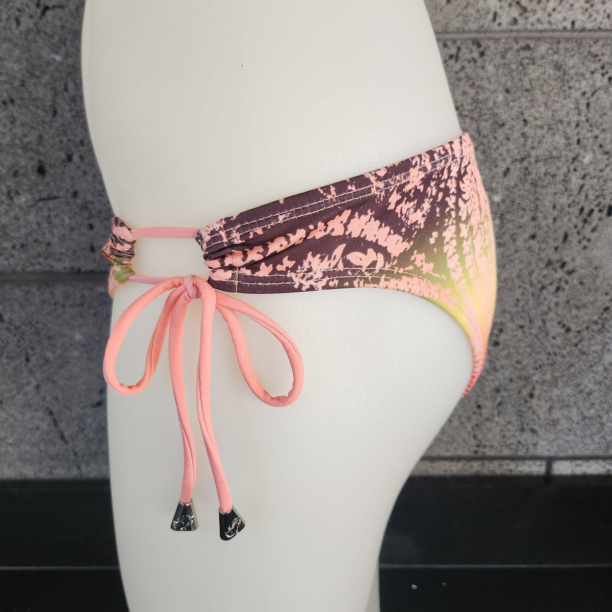 Loco Boutique bandana with keyhole gather design, featuring vibrant patterns and soft fabric, displayed flat on a white background.