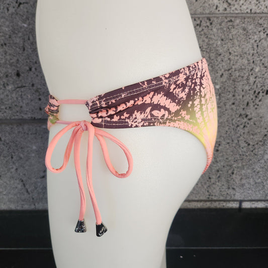 Loco Boutique bandana with keyhole gather design, featuring vibrant patterns and soft fabric, displayed flat on a white background.