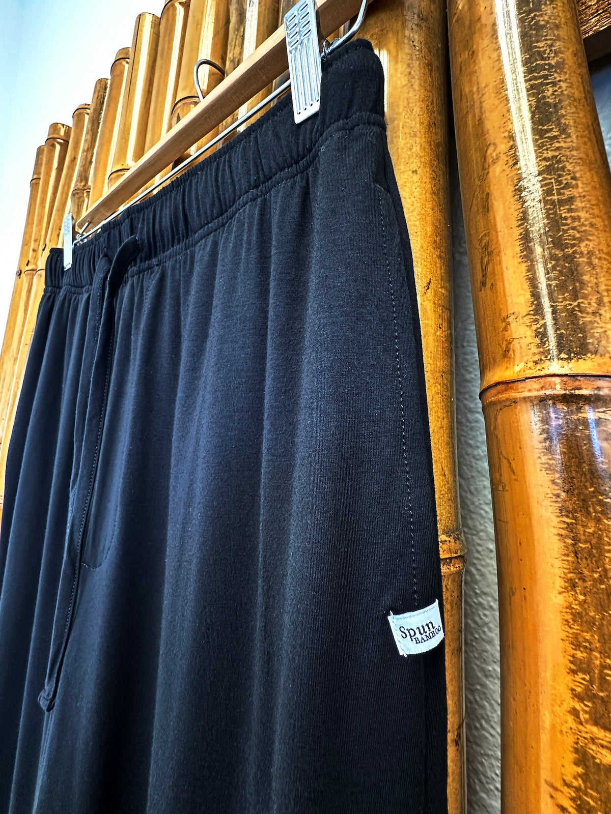 Men's black bamboo viscose lounge pants by Spun Bamboo, shown from the side view, featuring a relaxed fit and comfortable fabric.