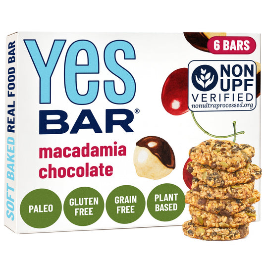 Box of six YES BAR® Macadamia Chocolate bars showing creamy chocolate coating with whole macadamia nuts inside.