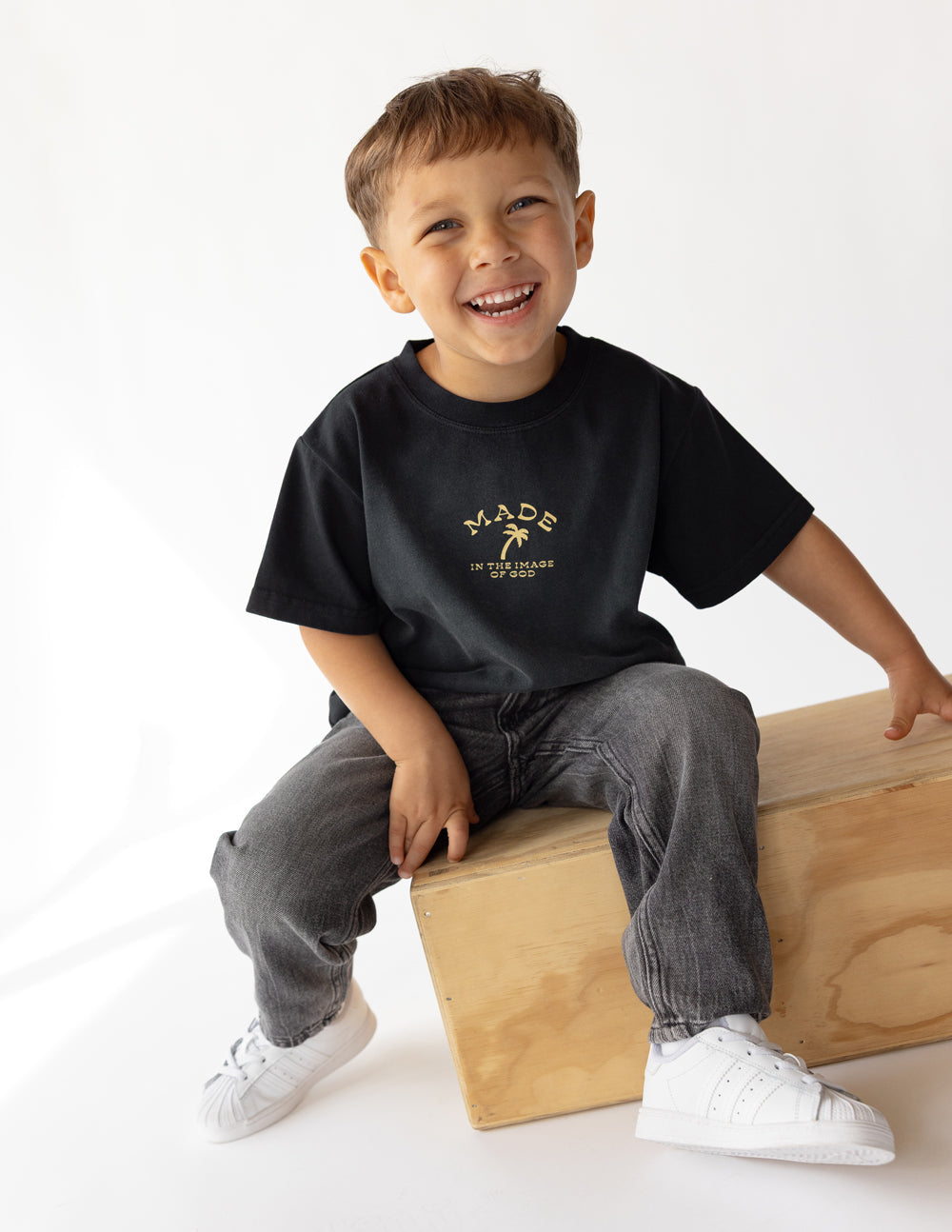 Bright kids' T-shirt by Elevated Faith featuring the "Made in the Image of God" design, with colorful text and playful style.