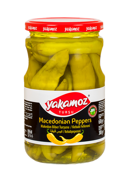 Glass jar of Yakamoz Macedonian pickles with spicy red pepper from S101, showcasing colorful pickled peppers in a clear jar.