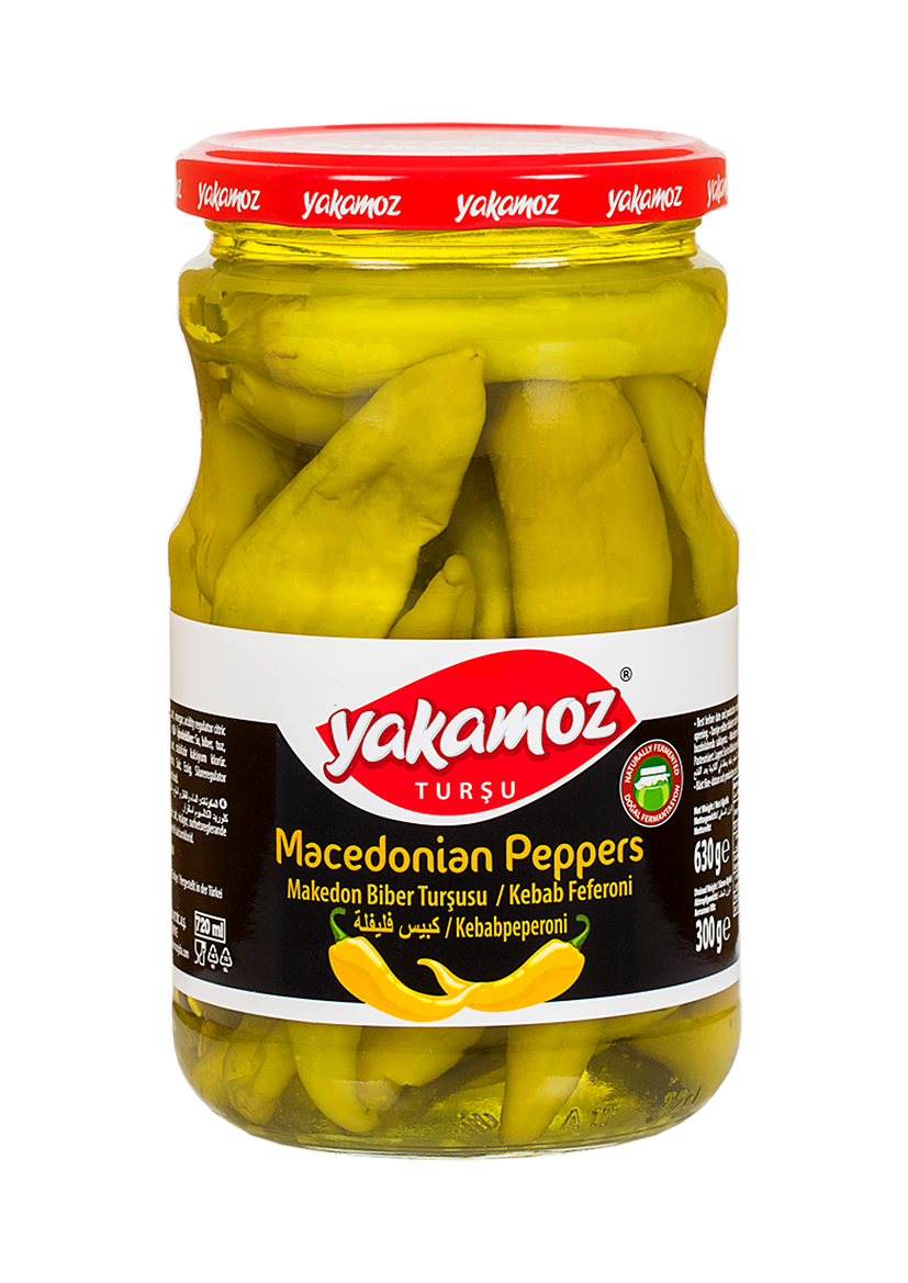 Glass jar of Yakamoz S101 pickled Macedonian peppers, vibrant red peppers submerged in brine, ready for culinary use.