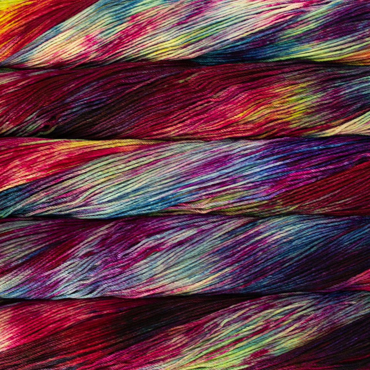Soft Malabrigo Arroyo yarn in vibrant colors, shown in a ball with textured fibers, by Darn Good Yarn for knitting or crochet projects.