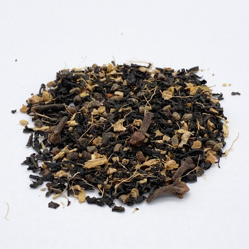 Loose leaf Masala Chai black tea blend from Novel Tea Book Shop, showcasing aromatic spices and dark tea leaves.