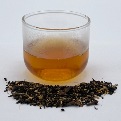 Loose leaf Masala Chai black tea from Novel Tea Book Shop, showing aromatic spices and rich dark tea leaves.