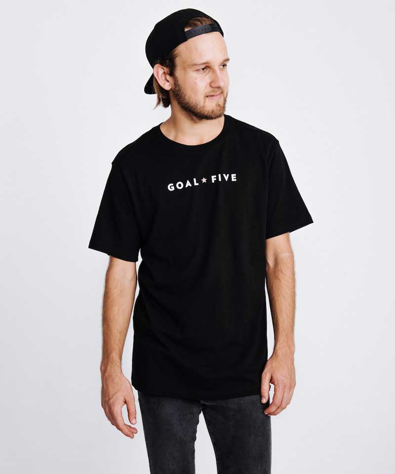 Men wearing Goal Five men's black cotton T-shirt in a lifestyle setting, showcasing casual comfort and stylish fit.