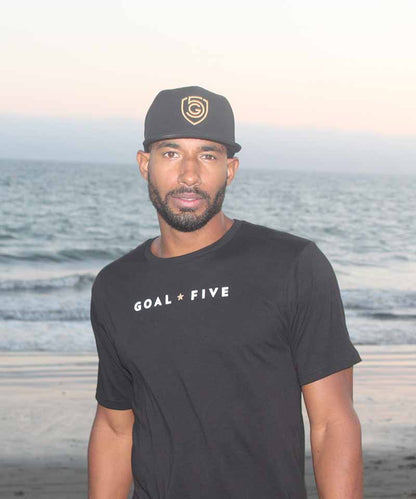 Men wearing Goal Five men's black cotton T-shirt, casual lifestyle clothing, showing front view and comfortable fit.