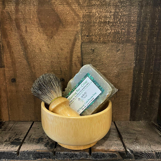 Men's shaving set by Soaplicity featuring bamboo handle razors and grooming accessories in a sleek, natural bamboo display.
