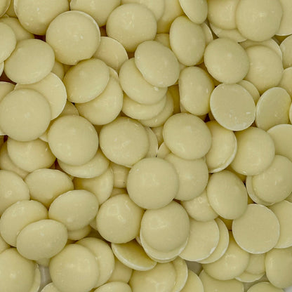 White vanilla-flavored Merckens chocolate coating and melting wafers in a bulk bag, ideal for candy making and baking.