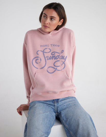 Unisex hoodie from Elevated Faith with "More Than Sunday" graphic, soft fabric, and casual fit, displayed on a plain background.